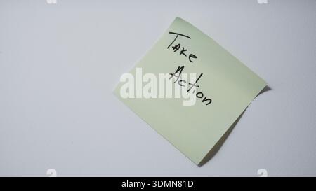 "Take Action" Handwritten on Green Sticky Note — Business Motivation and Proactive Mindset Concept Stock Photo