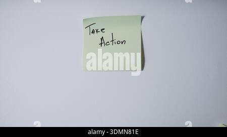"Take Action" Handwritten on Green Sticky Note — Business Motivation and Proactive Mindset Concept Stock Photo