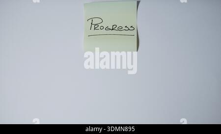 "Progress" Handwritten and Underlined on Green Sticky Note — Business Growth and Development Concept Stock Photo