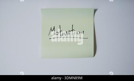Motivation sticky note on minimal white background Stock Photo