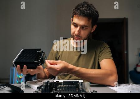 Computer technician installing cpu cooler on motherboard, performing precise desktop computer maintenance and hardware upgrade within professional Stock Photo