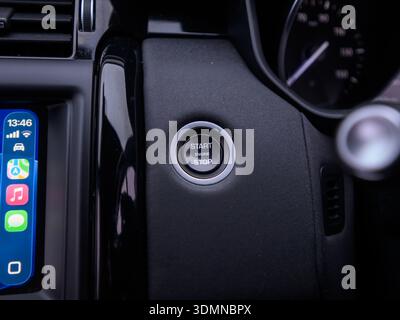 Close up of car engine start stop button on dashboard Stock Photo