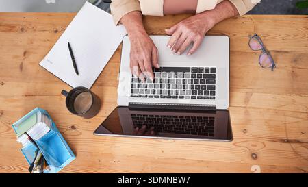 Woman Working On Laptop At Rustic Desk With Tablet Notebook Glasses And Coffee Stock Photo