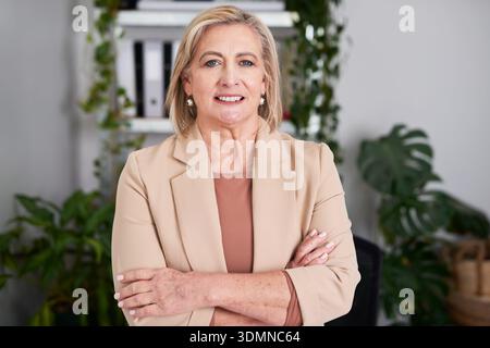 Confident Businesswoman Portrait In Office With Beige Blazer, Professional Leader, Smiling Female Executive Stock Photo