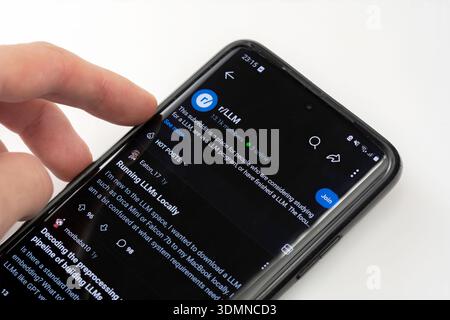 Person browsing r LLM subreddit on Reddit app, smartphone screen closeup. Large Language Models AI community, machine learning discussion, local LLMs Stock Photo