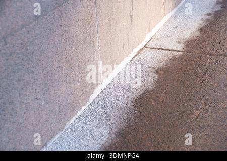 Technical salt and special chemicals on sidewalk in cold winter season Stock Photo