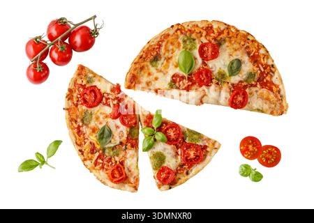 Vegetarian baked and sliced crusty pizza with mozzarella cheese, red cherry tomatoes, pesto sauce and green basil leaves flying isolated on white Stock Photo