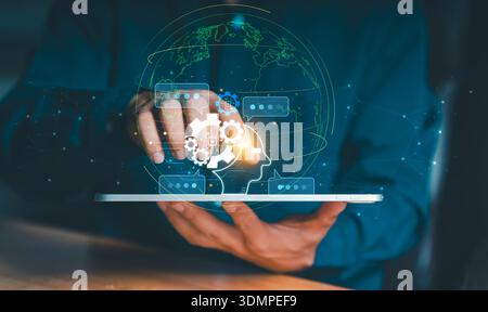 Businessman using tablet with global network interface and AI head icon. Concept of worldwide digital transformation, artificial intelligence connecti Stock Photo