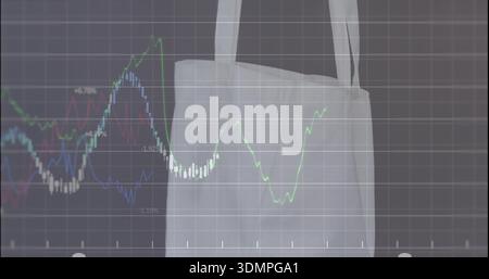 Displaying pale canvas tote bag hanging in studio, showing translucent grid and colored line charts Stock Photo