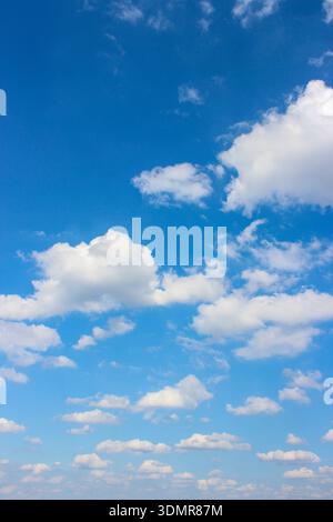 Background with clouds on blue sky. Sky view. Beautiful sunny sky. Clouds on blue sky. Sun shining through the puffy clouds. Stock Photo