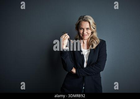 Glasses, stylist and portrait of business woman in studio for fashion designer, about us and confidence. Creative director, wardrobe tailor and Stock Photo
