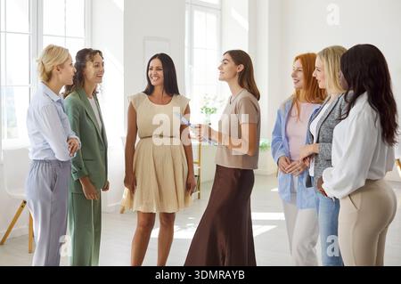 Team training workshop with women group engaged in coaching and discussion Stock Photo
