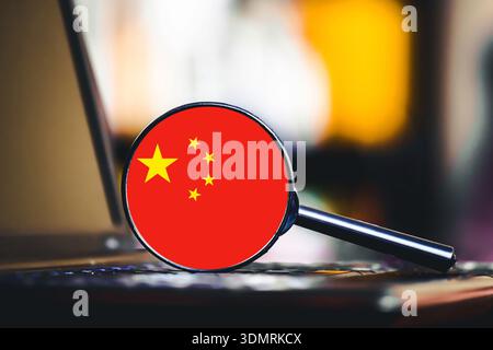 China flag symbol near laptop keyboard closeup. Technology and cybersecurity concept. Digital surveillance and global internet regulation idea. Stock Photo