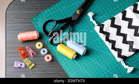 Sewing kit flat lay with fabric clips, bobbins, and pouch Stock Photo