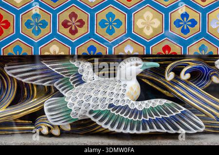 Bird carving on Nikko temple wall highlights Japanese artistry Stock Photo