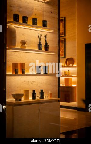 Milan, Italy - 2026, 3 Feb: Elegant Acqua di Parma fragrance display in a luxury boutique window, featuring illuminated shelves and sophisticated Ital Stock Photo