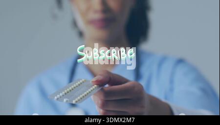 Offering female nurse in scrubs with stethoscope presenting blister pack in clinic Subscribe text Stock Photo