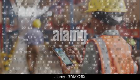 Using smartphone, worker in yellow hard hat, orange vest viewing binary digits at site, copy space Stock Photo