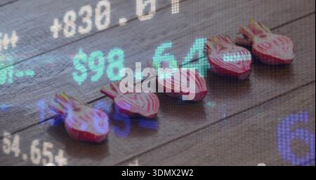 Displaying five halved striped beets showing rings on dark wood plank with financial tickers $98 Stock Photo