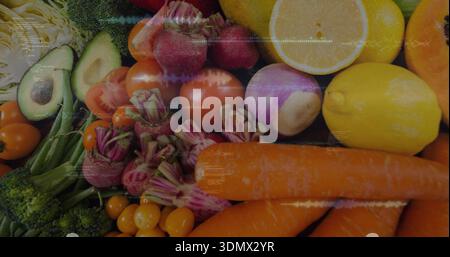 Showing cropped produce filling frame on dark slate, with carrots lemons avocados tomatoes broccoli Stock Photo