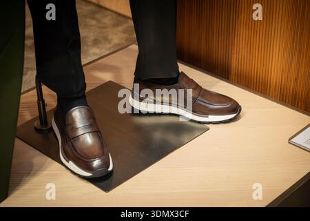 Milan, Italy - 2026, 3 Feb: Berluti FW25 brown leather sneakers showcased in a stylish store window, highlighting luxury craftsmanship and contemporar Stock Photo