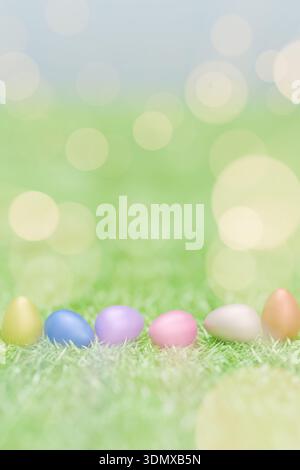 Pastel Easter eggs lined up on green grass with bright, dreamy bokeh lighting effects. 3d rendering Stock Photo
