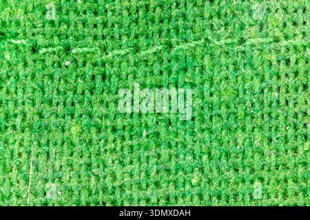 Green burlap textile showing a macro view of its rough woven threads and pattern Stock Photo