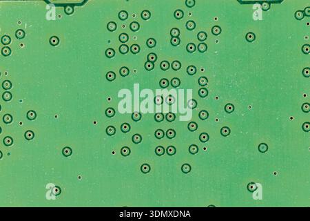 Green printed circuit board showing intricate electronic components and connections Stock Photo