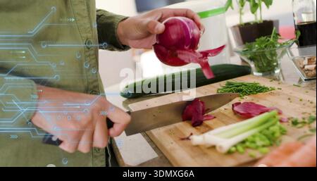 Chopping woman with chef knife wearing green shirt slicing red onion on wood board circuit overlay Stock Photo
