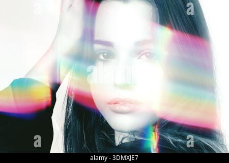 Woman's portrait with vibrant light refracting across her face and head Stock Photo