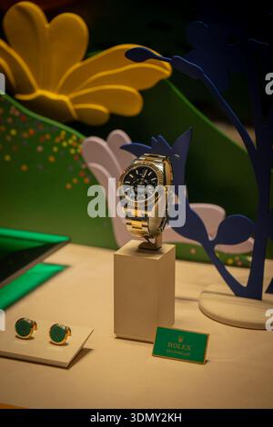 Milan, Italy - 2026, 3 Feb: Rolex FW25 luxury watch and cufflinks displayed with vibrant artistic decor, highlighting premium craftsmanship and modern Stock Photo