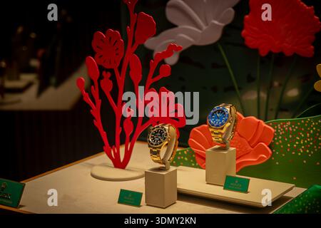 Milan, Italy - 2026, 3 Feb: Elegant Rolex watches showcased with vibrant floral decor, gold accents, and FW25 style, highlighting luxury and modern so Stock Photo
