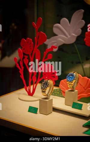 Milan, Italy - 2026, 3 Feb: Elegant Rolex watches showcased with vibrant floral decor, highlighting FW25 luxury trends and sophisticated style in a pr Stock Photo
