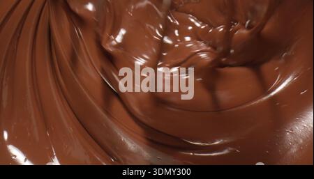 Chocolate melting in a bowl as it is prepared for dessert making in a kitchen during the afternoon Stock Photo