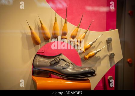 Milan, Italy - 2026, 3 Feb: Santoni FW25 luxury leather shoe showcased with artisanal tools, highlighting Italian craftsmanship and sophisticated fash Stock Photo