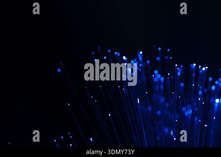 Blue neon light streaks create an enchanting abstract pattern, combined with captivating bokeh effects for a futuristic ambiance. Ideal for technology Stock Photo