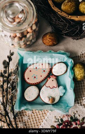 Celebrate Easter with beautifully decorated cookies shaped like eggs and chickens, surrounded by vibrant dyed eggs and a festive ambiance, perfect for Stock Photo