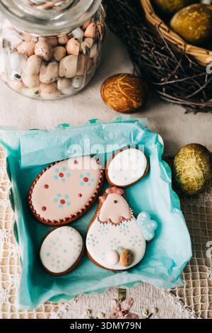 Delight in festive Easter cookies, beautifully decorated with pastel icing and polka dots. Nestled among colorful easter eggs, these treats celebrate Stock Photo