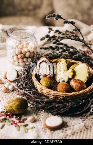 A festive Easter basket filled with beautifully decorated cookies and colorful Easter eggs, perfectly capturing the essence of springtime celebration Stock Photo