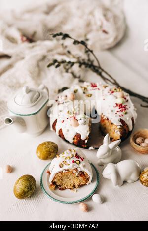Celebrate Easter with a beautifully decorated cake featuring luscious white icing, colorful sprinkles, and ornate eggs. Perfect for a charming holiday Stock Photo