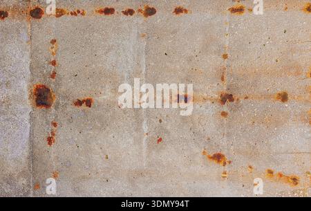 Close-up of a concrete surface showcasing prominent rust stains and geometric patterns. The texture adds an industrial and vintage feel, highlighting Stock Photo