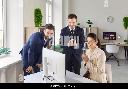 Business team celebrating results at computer, meeting success and strategy Stock Photo