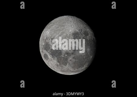 Detailed large moon isolated on dark black background. Stock Photo