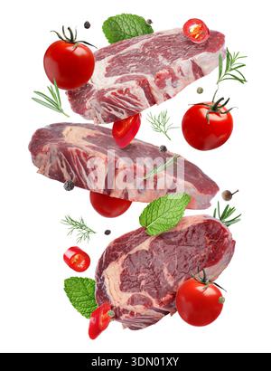 Fresh beef steaks falling on white background Stock Photo