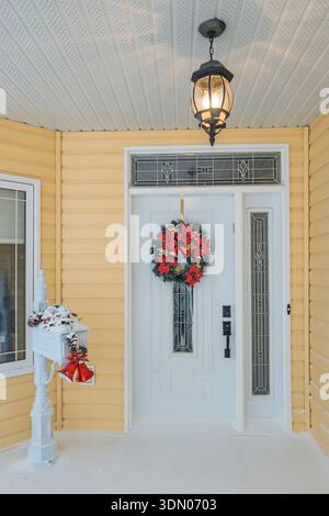 A front entrance door to a home decorated for Christmas in the winter at Winkler, Manitoba, Canada. Stock Photo