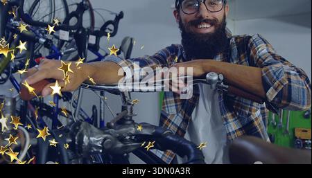 Leaning man wearing glasses cap flannel resting on bike handlebars in bike shop, with pegboard Stock Photo