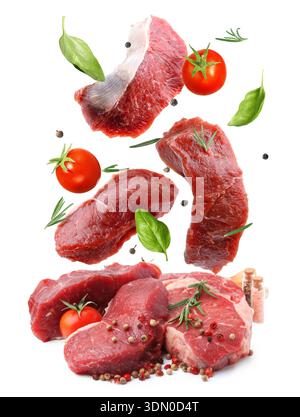 Fresh beef steaks falling on white background Stock Photo