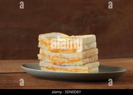 Close Up Kaya Toast Butter, Kopitiam Breakfast Style. Popular in Malaysia and Singapore. Isolated on Wooden Table Stock Photo
