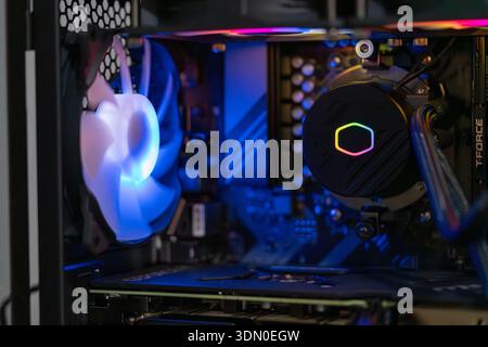 Gaming computer interior with RGB liquid cooling system and modern hardware components inside high performance desktop PC technology concept Stock Photo