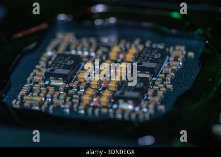 Macro close up of electronic circuit board with microchips and SMD capacitors on modern motherboard technology hardware concept Stock Photo